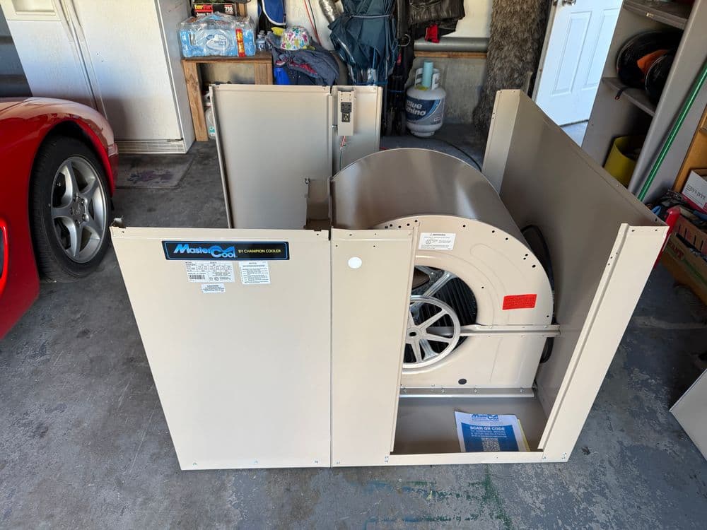Mobile Cool evaporative cooler in a garage, showcasing fan and control panel details.